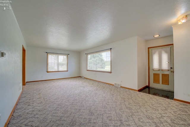 419 Kinney St, Bellevue, OH 44811 - spare room with baseboards, carpet floors, and a textured ceiling