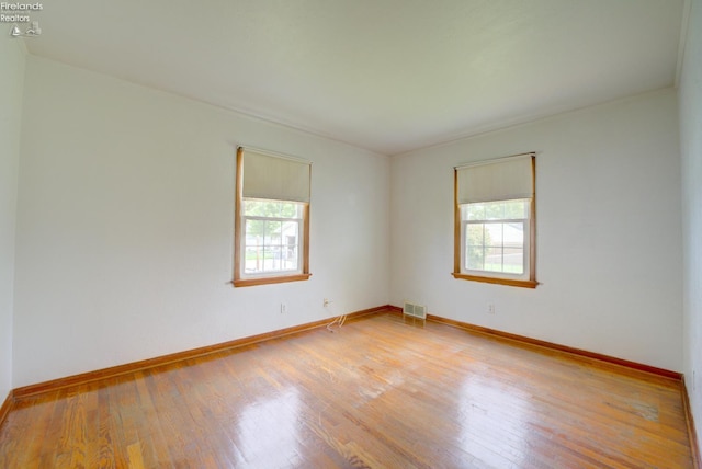 419 Kinney St, Bellevue, OH 44811 - empty room with healthy amount of natural light, wood finished floors, and baseboards