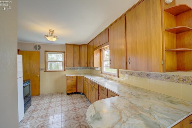 419 Kinney St, Bellevue, OH 44811 - kitchen with light countertops, open shelves, a sink, light floors, and ornamental molding