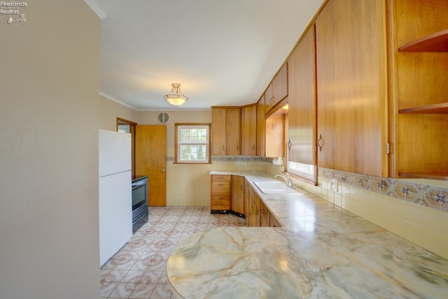 419 Kinney St, Bellevue, OH 44811 - kitchen with a sink, open shelves, light countertops, freestanding refrigerator, and stainless steel electric stove