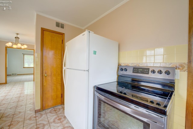 419 Kinney St, Bellevue, OH 44811 - kitchen with stainless steel electric range oven, a chandelier, crown molding, freestanding refrigerator, and light tile patterned floors