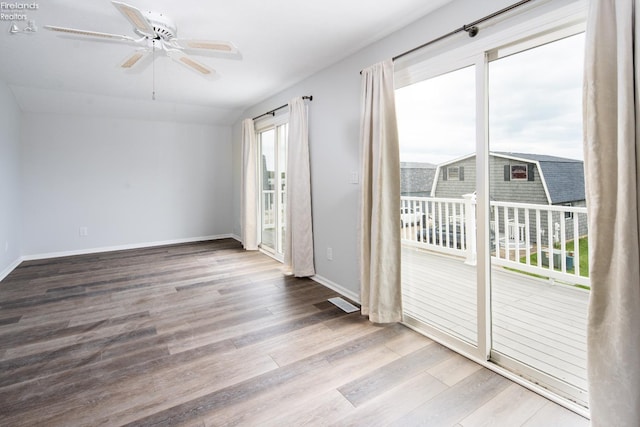 6039 E Harbor Rd Unit 8, Marblehead, OH 43440 - empty room featuring wood finished floors, ceiling fan, and baseboards