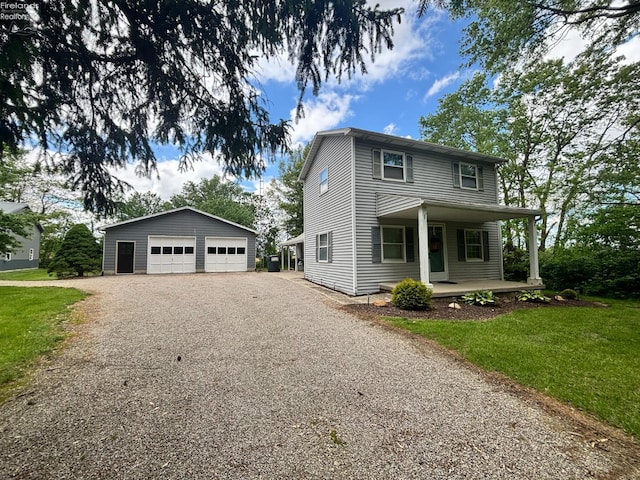 3960 Everingin Rd, Monroeville, OH 44847 - traditional home with a garage, an outbuilding, covered porch, and a front lawn