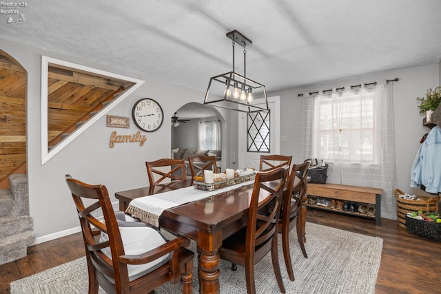 3960 Everingin Rd, Monroeville, OH 44847 - dining room featuring arched walkways, wood finished floors, and a textured ceiling