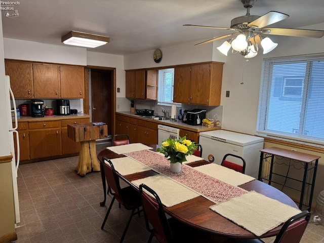 104 N Wood St, Fremont, OH 43420 - kitchen featuring brown cabinetry, white appliances, light countertops, a ceiling fan, and a sink