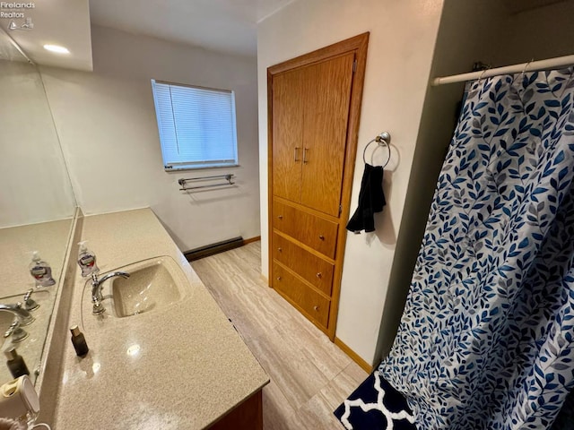 104 N Wood St, Fremont, OH 43420 - full bathroom with vanity, wood finished floors, a shower with shower curtain, and a baseboard radiator