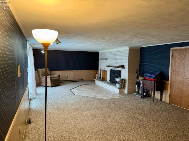 104 N Wood St, Fremont, OH 43420 - carpeted living room with wallpapered walls, a baseboard heating unit, and a brick fireplace