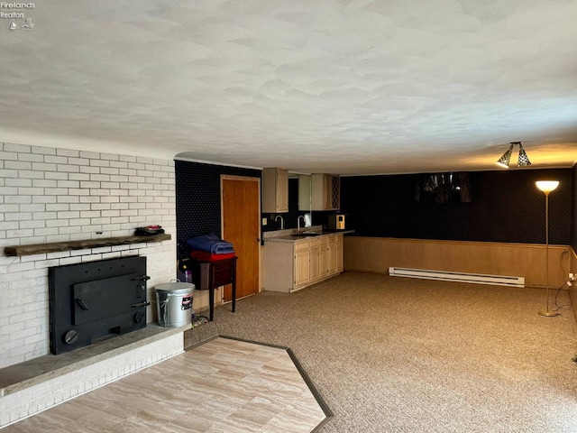 104 N Wood St, Fremont, OH 43420 - kitchen featuring a baseboard heating unit, a sink, and light carpet