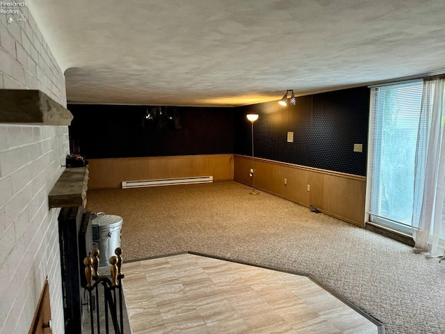 104 N Wood St, Fremont, OH 43420 - home theater with a baseboard heating unit, healthy amount of natural light, a wainscoted wall, light flooring, and light carpet