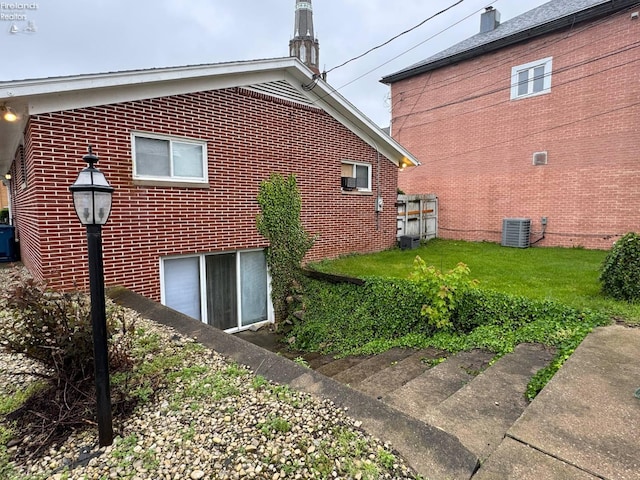 104 N Wood St, Fremont, OH 43420 - view of side of property with central air condition unit and brick siding