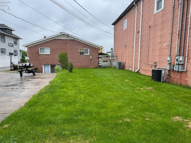 104 N Wood St, Fremont, OH 43420 - view of side of property featuring cooling unit, brick siding, and driveway