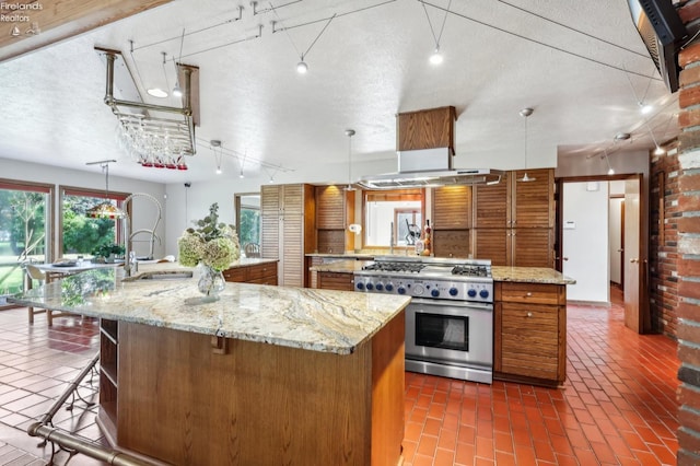 2203 Eagles Nest Cir, Sandusky, OH 44870 - kitchen featuring high end stainless steel range oven, a large island, brown cabinets, a sink, and open shelves