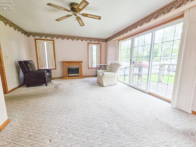 124 Walter St, Bellevue, OH 44811 - carpeted living area featuring ceiling fan, a glass covered fireplace, and baseboards