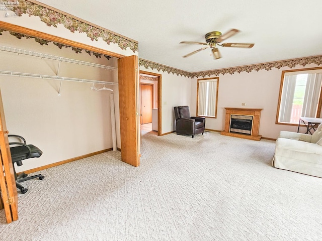 124 Walter St, Bellevue, OH 44811 - carpeted living area featuring a glass covered fireplace, a ceiling fan, and baseboards