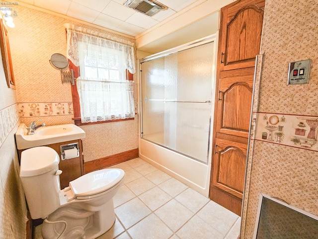124 Walter St, Bellevue, OH 44811 - full bathroom with wallpapered walls, toilet, tile patterned floors, shower / bath combination with glass door, and vanity