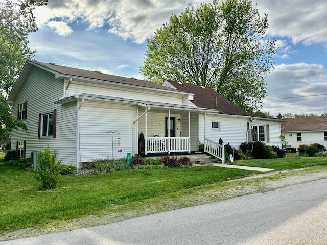 203 Washington St, Bettsville, OH 44815 - view of front of house featuring a porch and a front lawn