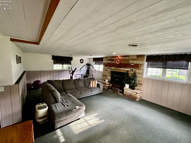 203 Washington St, Bettsville, OH 44815 - carpeted living room featuring wooden walls, healthy amount of natural light, a fireplace, and wood ceiling