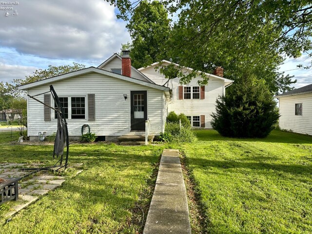 203 Washington St, Bettsville, OH 44815 - view of front of home featuring a front lawn and a chimney