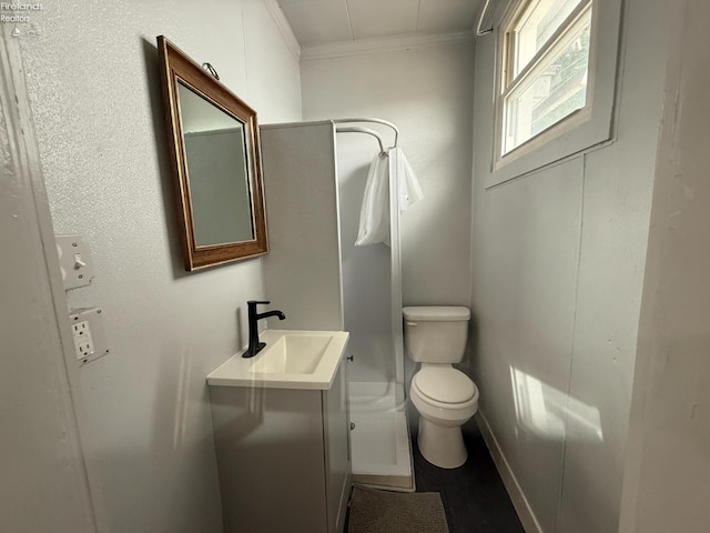 118 E 5th St, Port Clinton, OH 43452 - bathroom with crown molding, toilet, vanity, and baseboards