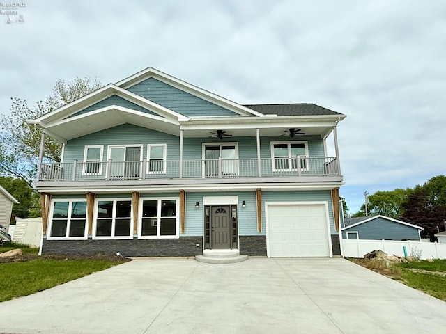 10556 E Bayshore Rd Unit 4C, Marblehead, OH 43440 - view of front facade featuring a balcony, a ceiling fan, stone siding, and a garage