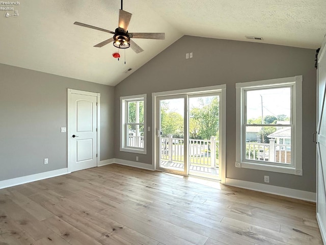 10556 E Bayshore Rd Unit 4C, Marblehead, OH 43440 - unfurnished room with vaulted ceiling, ceiling fan, healthy amount of natural light, light wood-style flooring, and baseboards