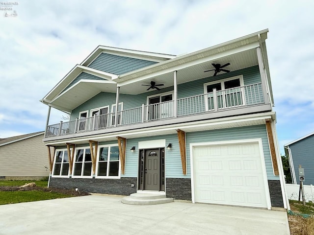10556 E Bayshore Rd Unit 4C, Marblehead, OH 43440 - view of front of property with a balcony, ceiling fan, a garage, and stone siding