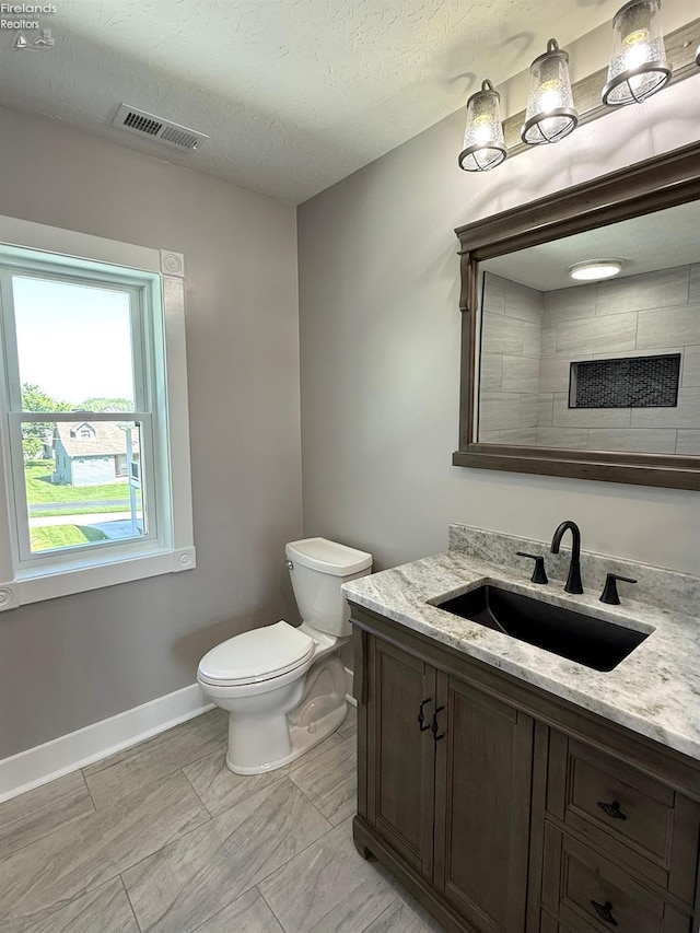 10556 E Bayshore Rd Unit 4C, Marblehead, OH 43440 - bathroom featuring toilet, baseboards, vanity, and a textured ceiling
