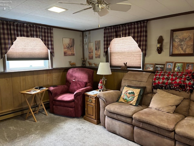 87 E Township Road 143, Tiffin, OH 44883 - carpeted living area with ceiling fan, ornamental molding, a baseboard heating unit, wooden walls, and wainscoting