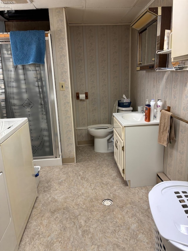 87 E Township Road 143, Tiffin, OH 44883 - bathroom featuring vanity, separate washer and dryer, toilet, a shower stall, and wallpapered walls