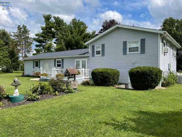 87 E Township Road 143, Tiffin, OH 44883 - rear view of house featuring a yard, a deck, french doors, cooling unit, and central air condition unit