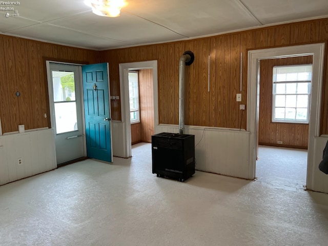 90 Newton St, Norwalk, OH 44857 - empty room featuring wood walls and a wood stove