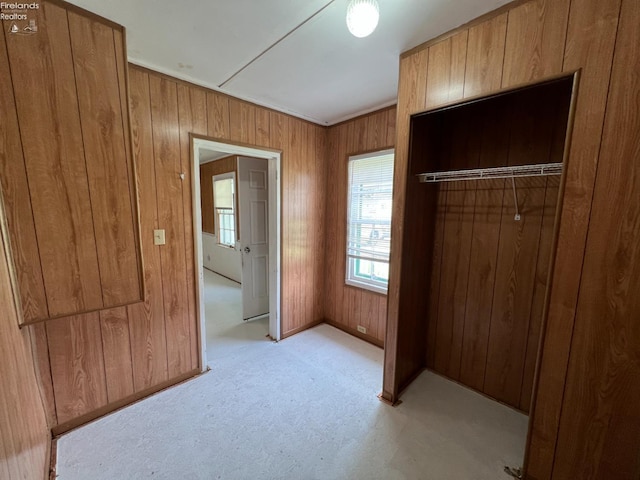 90 Newton St, Norwalk, OH 44857 - unfurnished bedroom with wooden walls, light colored carpet, and a closet