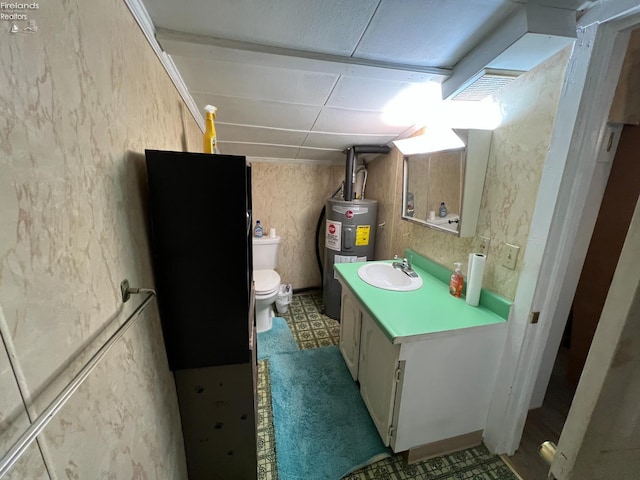 90 Newton St, Norwalk, OH 44857 - bathroom with electric water heater, vanity, toilet, and tile patterned floors