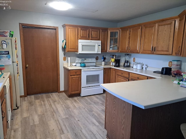5890 E Sr 18, Republic, OH 44867 - kitchen with white appliances, brown cabinetry, light wood-style floors, light countertops, and a peninsula