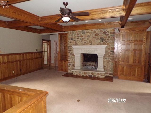 408 W Main St, Bellevue, OH 44811 - unfurnished living room featuring ceiling fan, beamed ceiling, carpet floors, wainscoting, and a fireplace