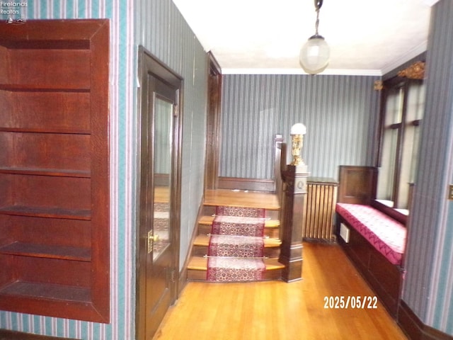 408 W Main St, Bellevue, OH 44811 - staircase featuring wallpapered walls, wood finished floors, radiator heating unit, and crown molding