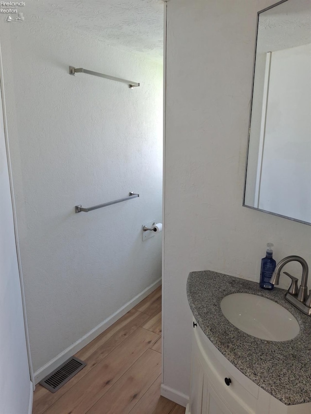 119 Michigan Ave, Huron, OH 44839 - bathroom featuring wood finished floors, vanity, and baseboards