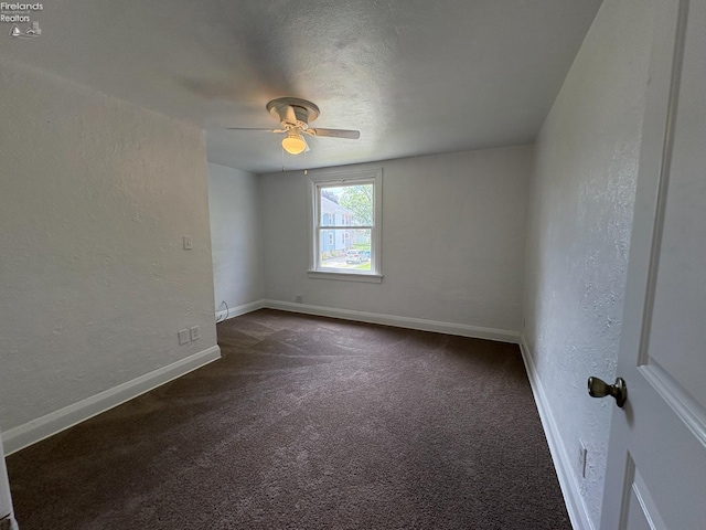 427 N Clover St, Fremont, OH 43420 - empty room with a textured wall, dark carpet, ceiling fan, baseboards, and a textured ceiling