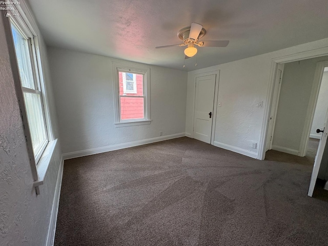427 N Clover St, Fremont, OH 43420 - empty room with a ceiling fan, dark colored carpet, baseboards, and a textured wall