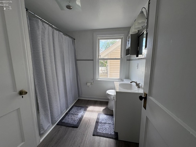 427 N Clover St, Fremont, OH 43420 - full bathroom with vanity, toilet, wood finished floors, and baseboards