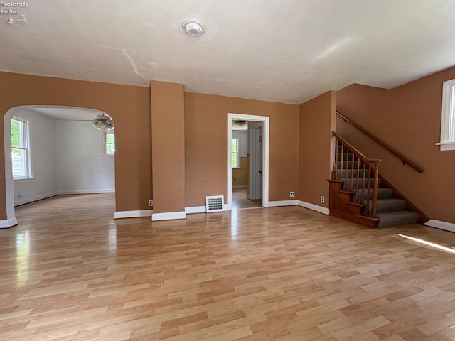 427 N Clover St, Fremont, OH 43420 - empty room with arched walkways, light wood finished floors, a ceiling fan, and baseboards