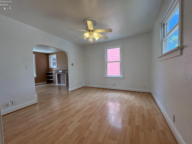 427 N Clover St, Fremont, OH 43420 - spare room featuring arched walkways, healthy amount of natural light, light wood-type flooring, and ceiling fan
