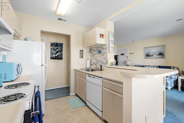 326 Clinton Reef Dr Unit 326, Port Clinton, OH 43452 - kitchen with white appliances, a sink, decorative backsplash, light countertops, and a peninsula