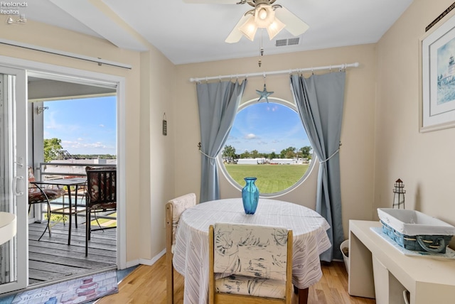 326 Clinton Reef Dr Unit 326, Port Clinton, OH 43452 - dining space featuring light wood finished floors, ceiling fan, and plenty of natural light
