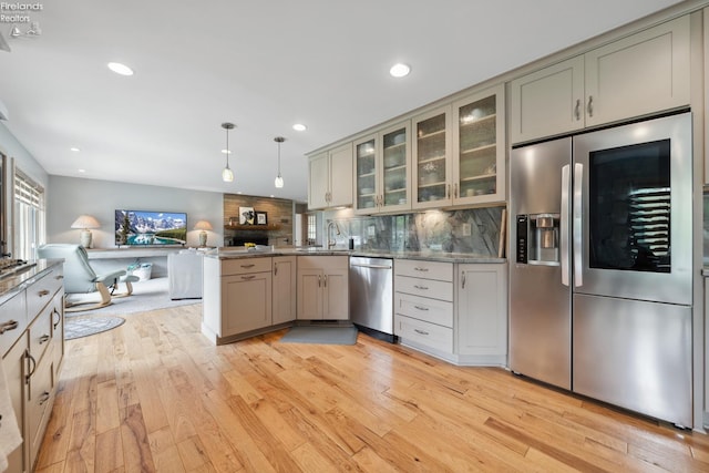 3999 NE Catawba Rd Unit 29, Port Clinton, OH 43452 - kitchen with stainless steel appliances, a peninsula, open floor plan, light wood-type flooring, and recessed lighting