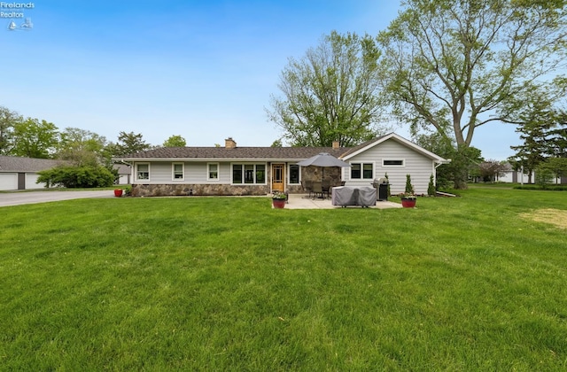 3999 NE Catawba Rd Unit 29, Port Clinton, OH 43452 - back of house featuring a chimney, a yard, stone siding, and a patio area