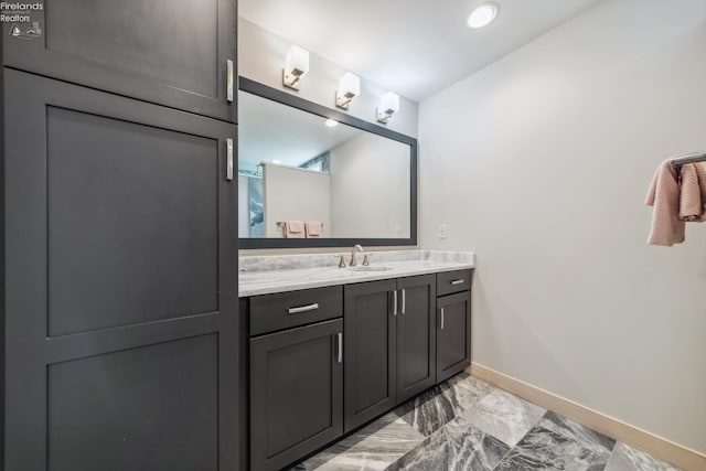 3999 NE Catawba Rd Unit 29, Port Clinton, OH 43452 - bathroom featuring baseboards, vanity, and marble look tiles