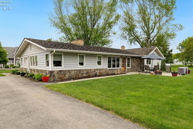 3999 NE Catawba Rd Unit 29, Port Clinton, OH 43452 - ranch-style home featuring a chimney, stone siding, a front lawn, and a patio