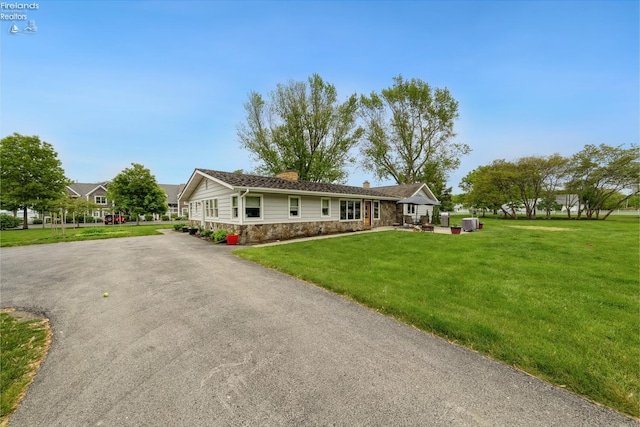 3999 NE Catawba Rd Unit 29, Port Clinton, OH 43452 - single story home featuring stone siding, a chimney, a front yard, and driveway
