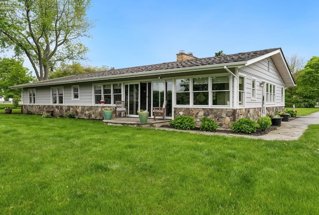 3999 NE Catawba Rd Unit 29, Port Clinton, OH 43452 - rear view of property featuring a chimney, stone siding, and a yard